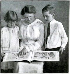 Representative with Children Looking at New Color Plate Catalog